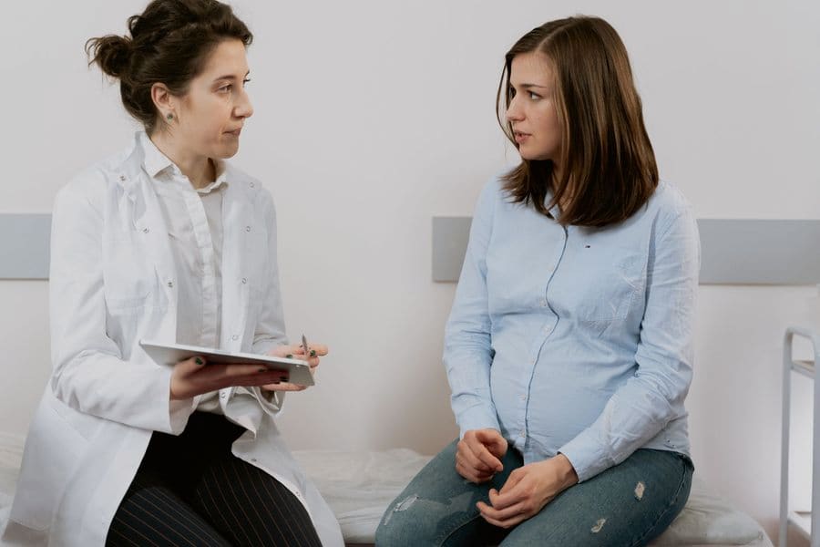 Profesional de salud atendiendo un control prenatal a una gestante en el consultorio
